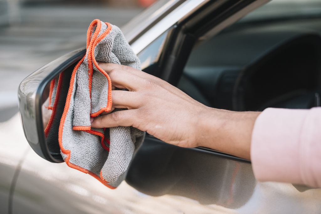 hand cleaning rear view mirror